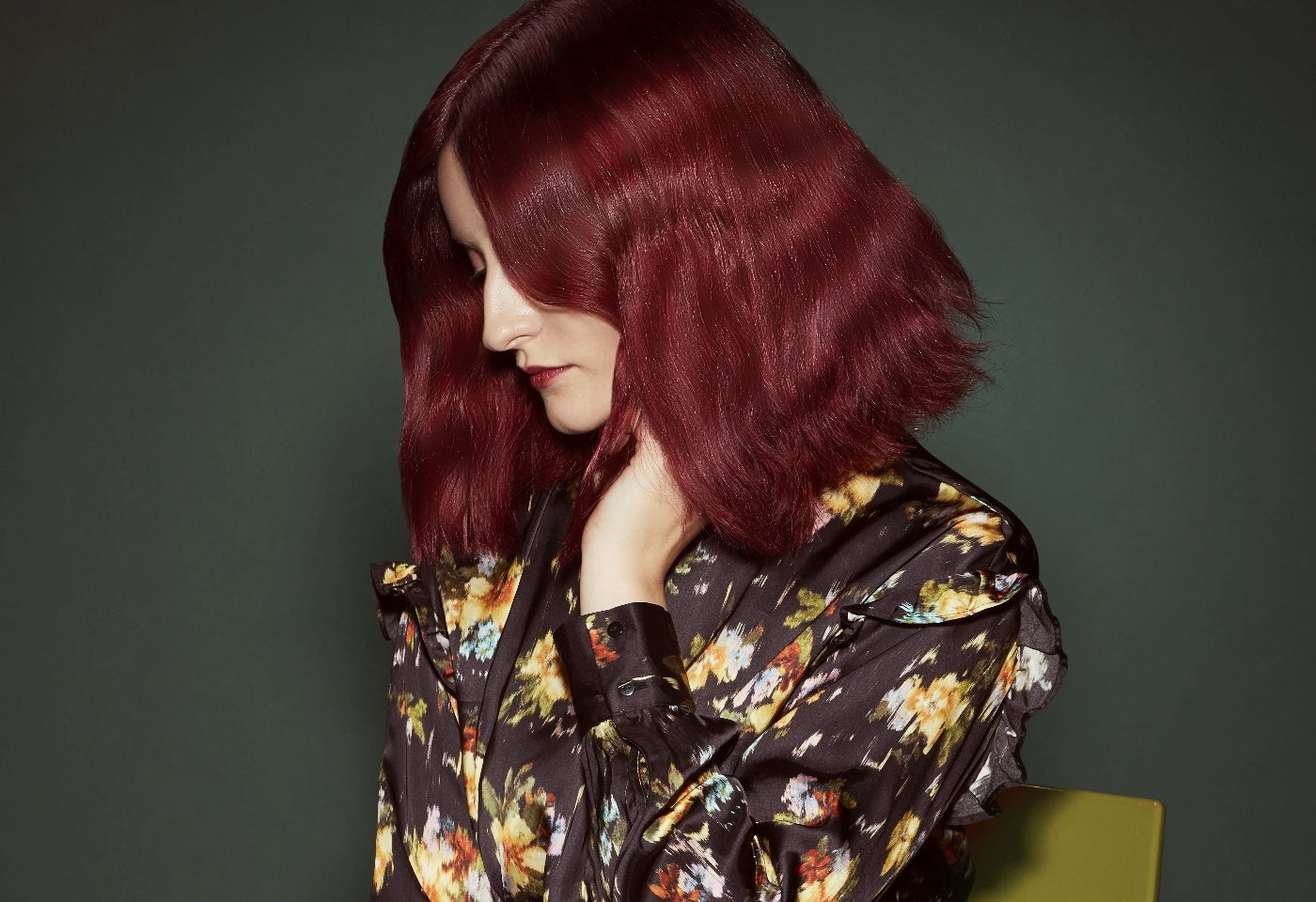 A woman with short red hair looking down